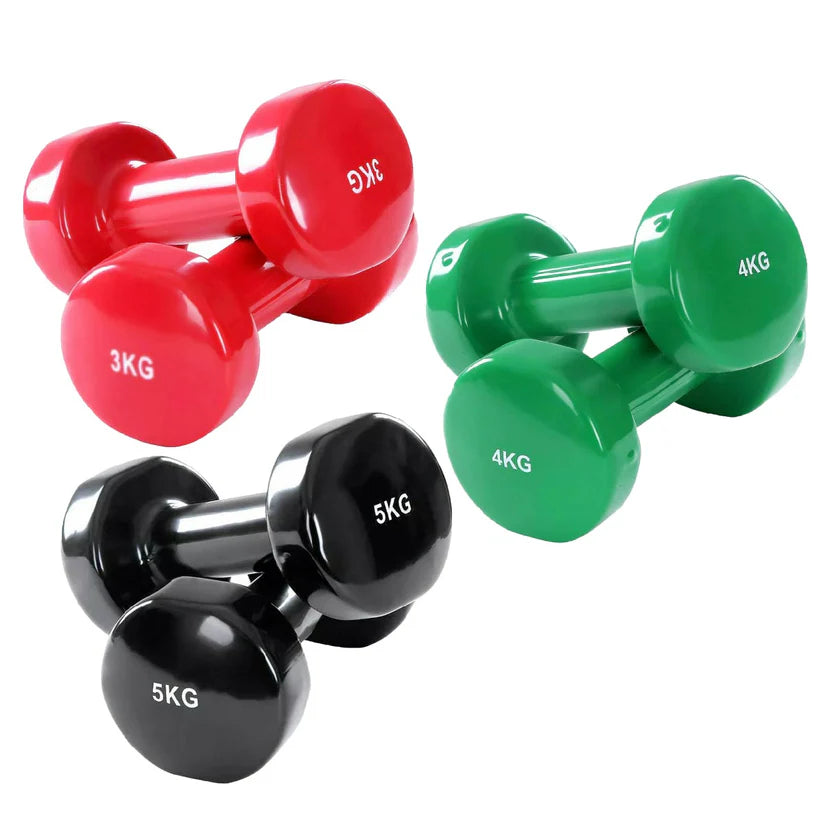 Set of red, green, and black dumbbells with weight markings on a white background