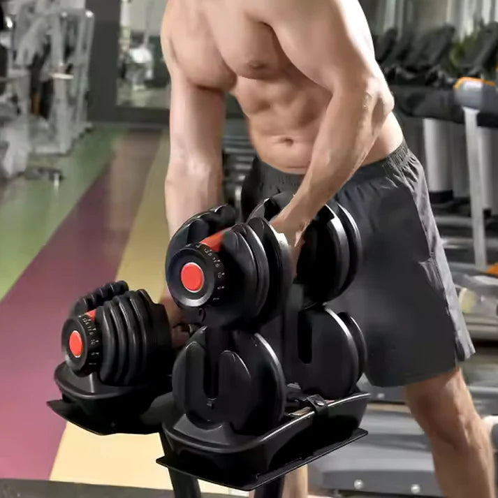 Person using adjustable dumbbells in a gym setting