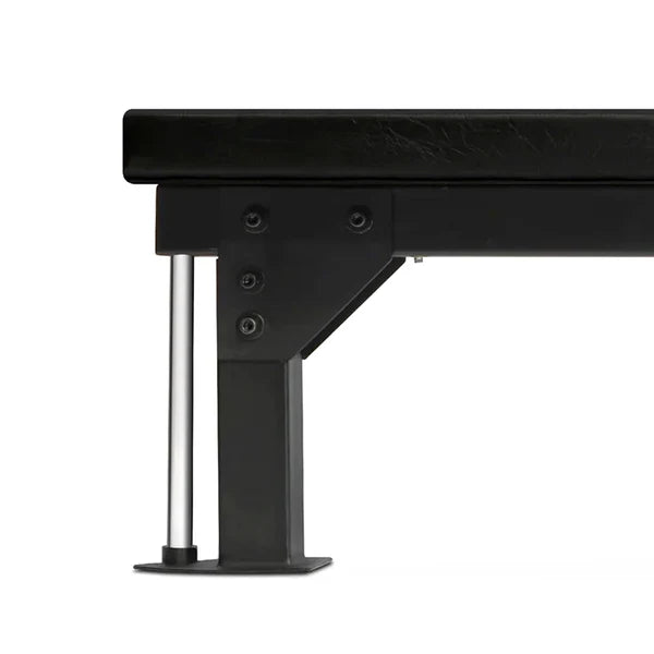 Close-up of a black metal bed frame with a white background