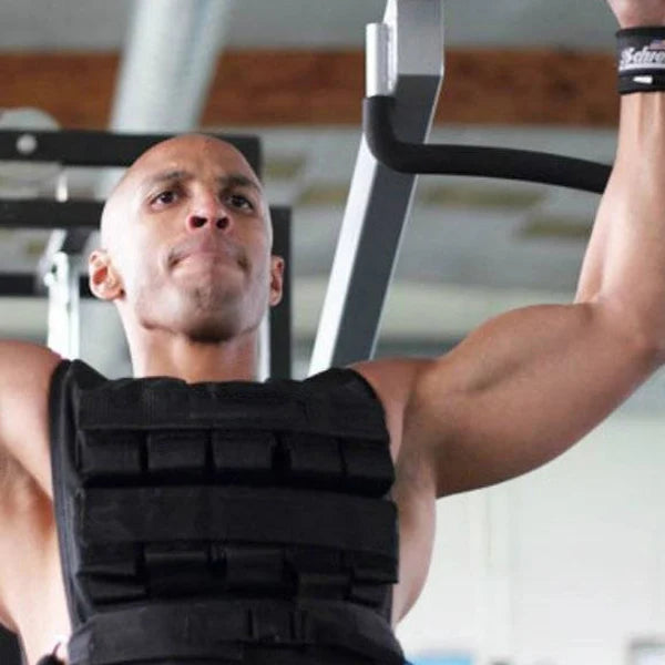 Man exercising with a weight vest in a gym setting