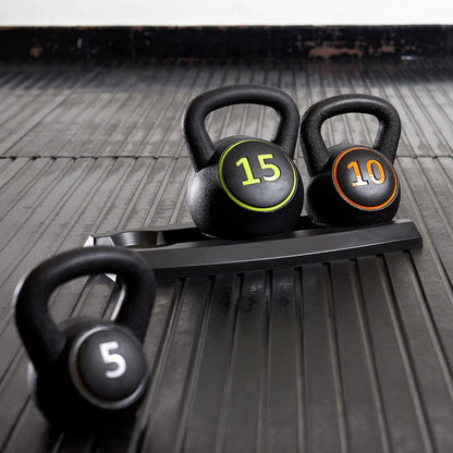 Three kettlebells with weights on a wooden floor