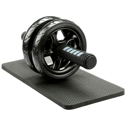 Black ab roller on a black mat with a white background