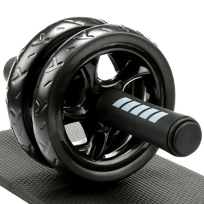 Black ab roller on a gray mat with a white background