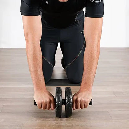 Person using an ab roller on a wooden floor