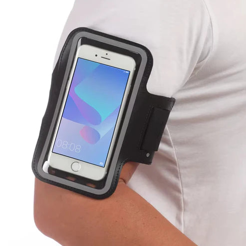 Person wearing a black arm band with a smartphone on a white background
