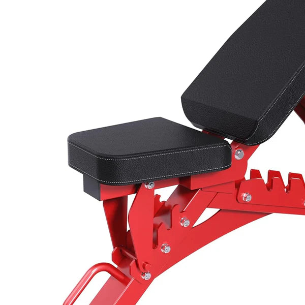 Red weight bench with black padding on a white background