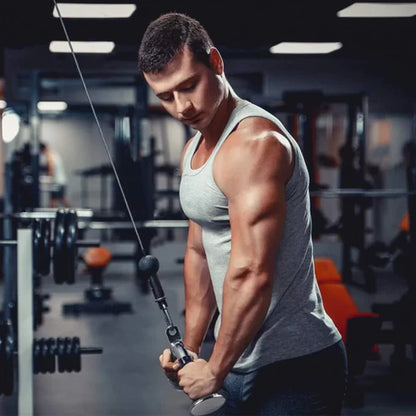 Muscular man exercising with cable machine in a gym