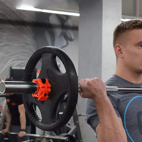 Person lifting a barbell with weight plates in a gym setting