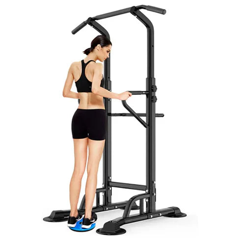 Woman using a black pull-up bar station on a white background