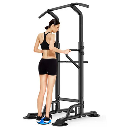 Woman using a black pull-up bar station on a white background