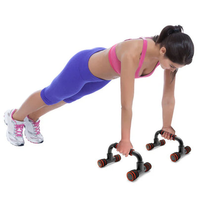 Woman exercising with push-up bars on a white background
