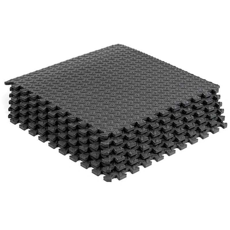 Stack of gray interlocking foam mats on a white background