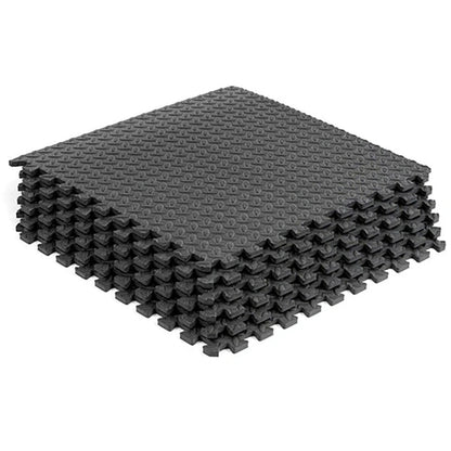 Stack of gray interlocking foam mats on a white background