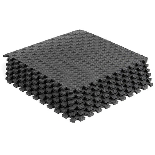 Stack of gray interlocking foam mats on a white background