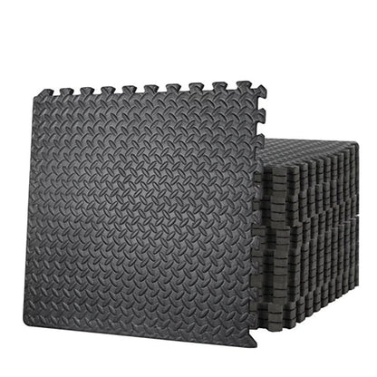 Stack of black interlocking foam mats on a white background