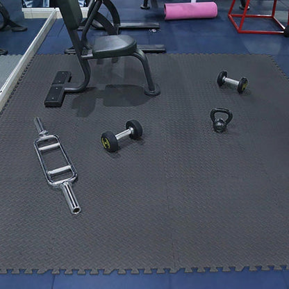 Gym equipment on a black mat with blue flooring