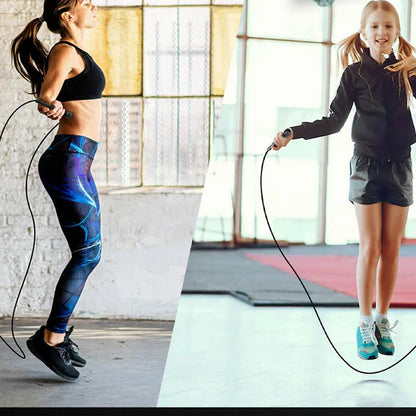 Two women exercising with jump ropes indoors.