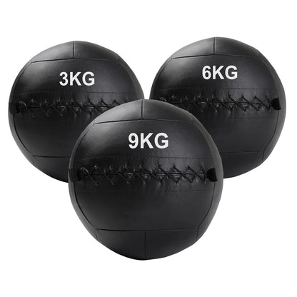 Three black wall balls with weight markings on a white background