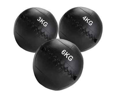 Three black weighted medicine balls with weight markings on a white background